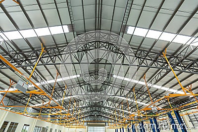 Steel roof truss in car repair center, Steel roof frame Under construction, The interior of a big industrial building or factory Stock Photo