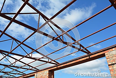 Steel roof trusses details. Steel roof trusses sitting on concrete pole view from inside home factory. Stock Photo