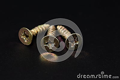 Steel screws on black background, head view Stock Photo