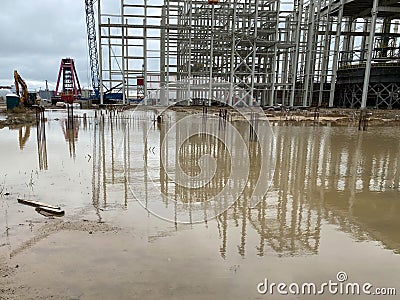 Steel Structure Warehouse Building. Industrial Building on light gauge steel framing. Frame of modern hangar or factory. Truck Editorial Stock Photo