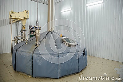Steel tank for mash fermentation with sight glass in modern brewery. Stock Photo