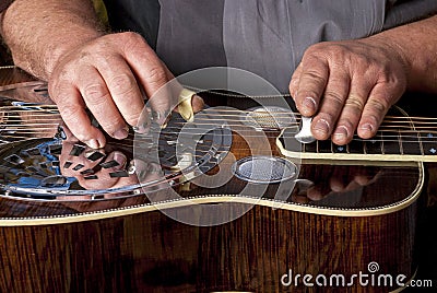 Steel topped Dobro guitar is being played Stock Photo