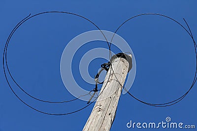 Old twisted wire on a wooden pole Stock Photo