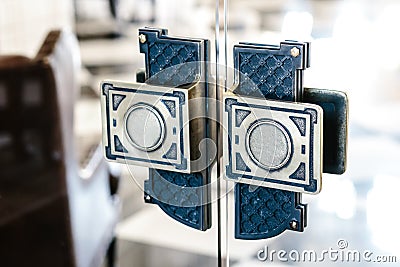 Steel, vintage ornate handles on the glass doors Stock Photo