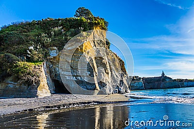 Steep and dangerous White rocks on the Pacific coast. Sunrise. Exotic journey to the end of the world. North Island, New Zealand Stock Photo
