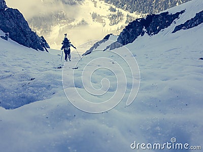 Steep icy slope with blurred alpinist. Stock Photo