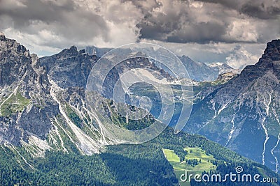 Steep ridges of Sexten Dolomites over forested valleys in Italy Stock Photo