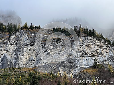 Steep stone cliffs and vertical rocks above the alpine river Tamina and over the Taminatal valley, VÃ¤ttis - Canton of St. Gallen Stock Photo