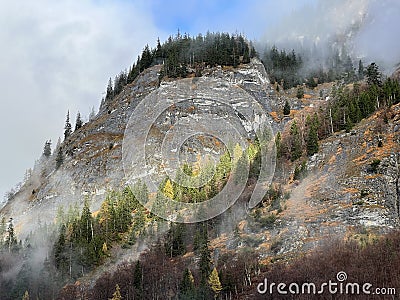 Steep stone cliffs and vertical rocks above the alpine river Tamina and over the Taminatal valley, VÃ¤ttis - Canton of St. Gallen Stock Photo