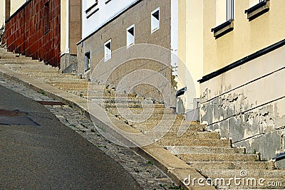 A steep street with staircase on sidewalk Stock Photo