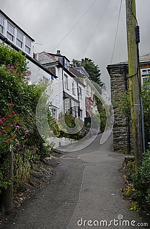 Steep, winding path among a cluster of cottages, Port Isaac, Cornwall, UK Editorial Stock Photo