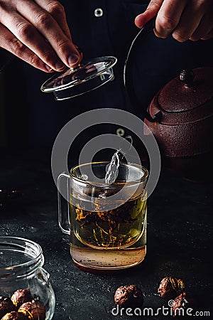 Steeping red tea in glass mug Stock Photo