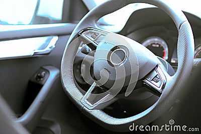 Steering and instrument panel in the car close-up. Left-hand drive. The latest technology and brand cars. Driving Stock Photo