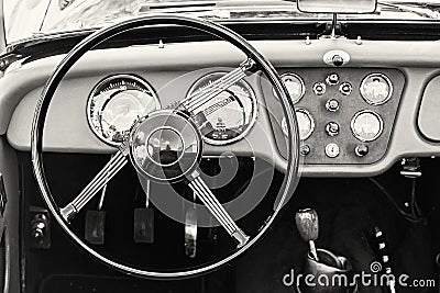 Steering wheel and dashboard in historic vintage car, black and Stock Photo