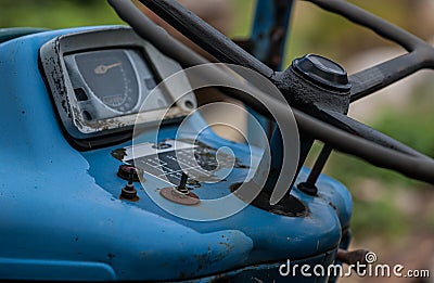 Steering wheel and dashboard of an old, blue Ford tractor.. Editorial Stock Photo