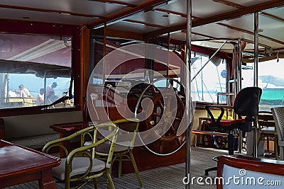 Steering wheel and engine controls on the ship bridge of a pleasure craft Stock Photo