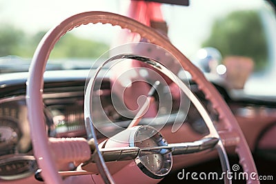 The steering wheel of a pink classic car Stock Photo