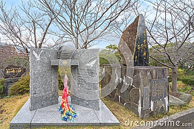 Stele dedicated to the Japanese haiku poet Haruto Kuma aside an atomic bomb memorial monument. Editorial Stock Photo