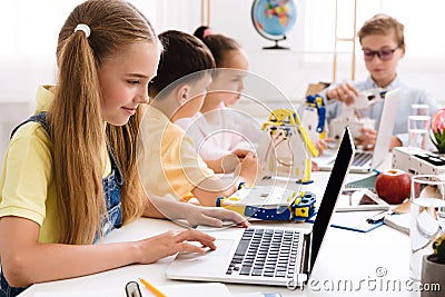 Stem education. Girl programming diy robot with laptop Stock Photo