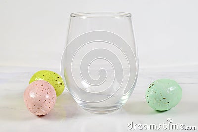 Stemless wineglass mockup with colorful Easter eggs Stock Photo