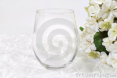 Stemless wineglass mockup with white flowers Stock Photo
