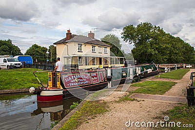 A narrow boat enters the lock at Stenson, Derby Editorial Stock Photo