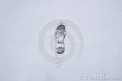 A step against snow background. footprint on white snow background of boots. Human trace on snow Stock Photo