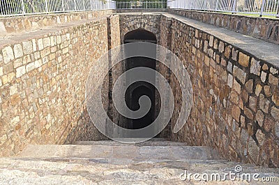 Step going down towards old well which is used for storage of water Stock Photo