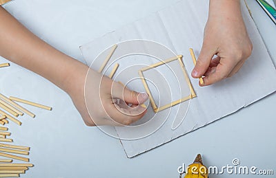 step-by-step instructions for creating a house from bamboo sticks. children`s creativity, manual work, online classes. step 1. th Stock Photo