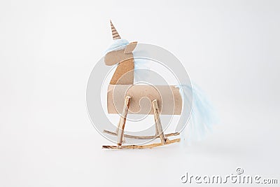 Step-by-step guide for creating a unicorn craft using simple materials. DIY unicorn project with cardboard tube, sticks Stock Photo
