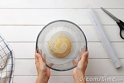 Step by step recipe galette or pie with nectarines. Female hands cover the dough with plastic wrap. Stock Photo