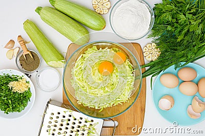 Step-by-step recipe to cook pancakes of zucchini and greens on a light background. with the addition of eggs, flour, garlic, Stock Photo