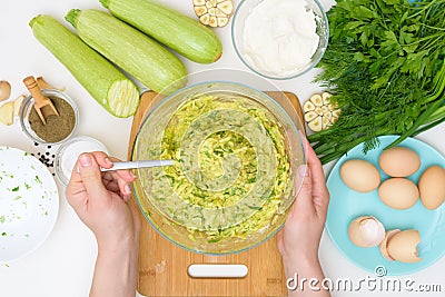 Step-by-step recipe to cook pancakes of zucchini and greens on a light background. with the addition of eggs, flour, garlic, Stock Photo