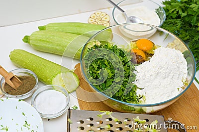 Step-by-step recipe to cook pancakes of zucchini and greens on a light background. with the addition of eggs, flour, garlic, Stock Photo