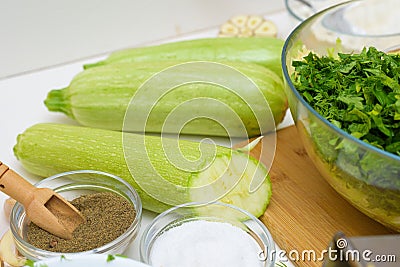 Step-by-step recipe to cook pancakes of zucchini and greens on a light background. with the addition of eggs, flour, garlic, Stock Photo