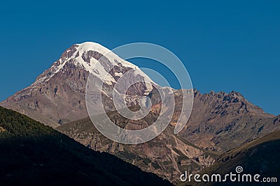 Stepantsminda - Amazing morning view on the summit of Mount Kazbegi, Georgia, Caucasus. Stock Photo