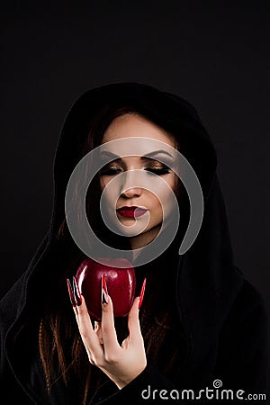 Stepmother watching at poisoned red apple Stock Photo