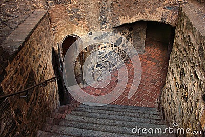 Stepped descent into the dungeon of the medieval castle Stock Photo