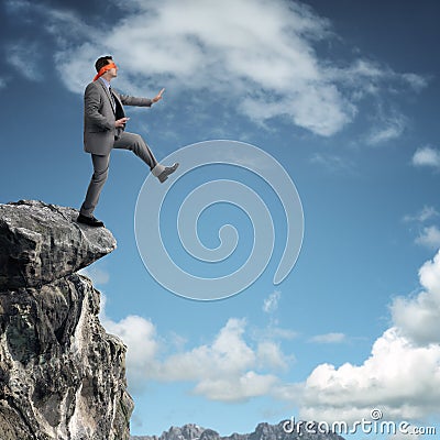 Stepping off a cliff ledge Stock Photo