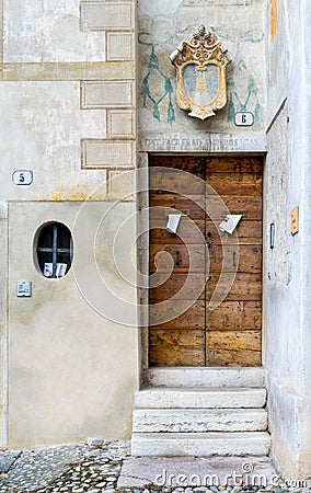 Steps leading to an ancient wooden door. Editorial Stock Photo