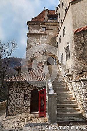 Steps of a stone staircase leading to the medieval Bran castle Dracula`s castle in Romania Editorial Stock Photo