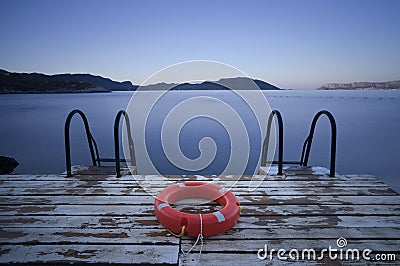 Steps to sea and Lifebuoy Stock Photo