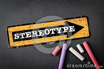 Stereotype. Yellow directional arrow with text on a dark chalkboard background Stock Photo