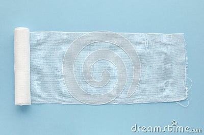 Sterile bandage on a blue background, top view, copy space. White medical cotton bandage on a blue background, copy Stock Photo