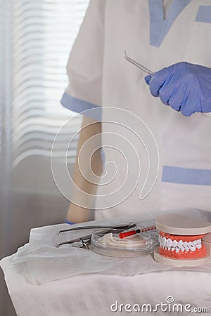 Sterile cotton napkins, jaw model and stomatological tools on a table Stock Photo