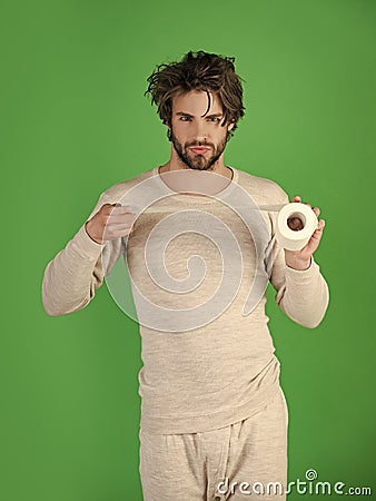 Sterility and purity. Man with serious face hold toilet paper, single. Stock Photo