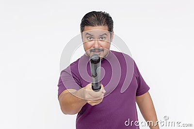A stern man pointing at someone with a baton, giving a warning. Hostile person with a blunt weapon. Isolated on a white background Stock Photo