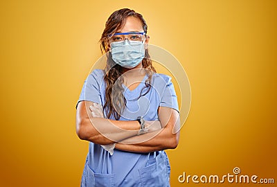 Stern and strong filipina nurse with arms crossed wearing PPE Stock Photo