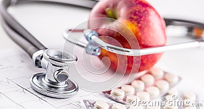 Stethoscope apple and pills on white background Stock Photo