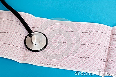 Stethoscope and cardiogram results on blue background Stock Photo